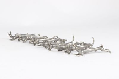 a group of silver metal animals on a white background