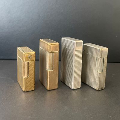three lighters sitting side by side on a black surface