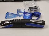 an image of a hair clipper, comb, scissors, and other items