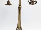 une lampe de table en laiton ancien à laquelle sont fixées deux ampoules