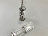 a small glass bottle and a small glass bottle on a table