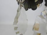 pair of silver and glass earrings with flowers and leaves hanging from them