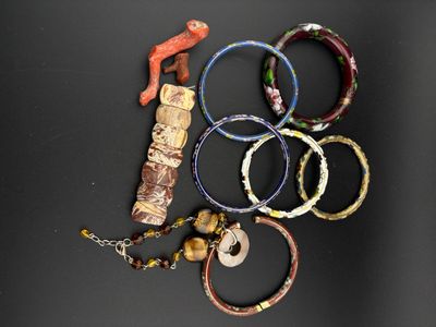 many bracelets that have been placed on a black surface