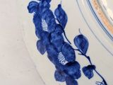 a blue and white plate with blue flowers on it