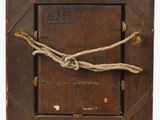 an old wooden picture frame with a rope wrapped around it
