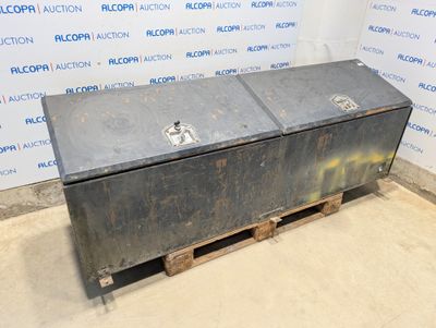 an old metal box sitting on top of a pallet in front of a wall