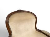 an image of a chair with a beige upholstered cushion and a wooden frame