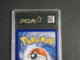 the pokemon card is in a plastic case on a table