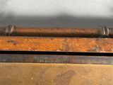 a picture of a wooden box with a chain hanging from it