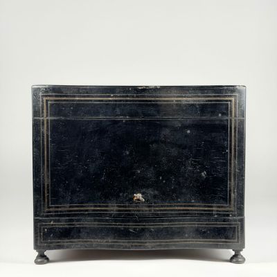 an old black chest of drawers with two drawers on each side and a drawer on the other side