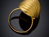 a close up of a gold ring on a black surface