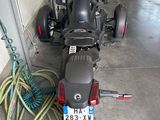 a motorcycle that is parked in a garage with a hose attached to it