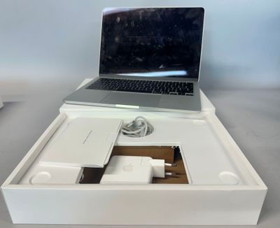 a white box with a laptop and a charger in it