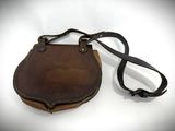 brown leather purse with strap on white background