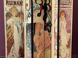 four paneled art nouveau style screen with a woman in a dress