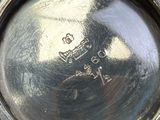 a close up of a silver plate with a picture on it