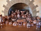 many different types of copperware on the table