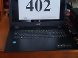 a laptop computer sitting on a desk in a room