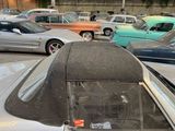 many cars parked in a parking lot next to each other