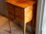a small wooden table with a drawer on top of it