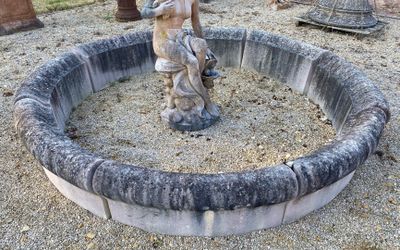 a statue of a man holding a bird in a stone ring