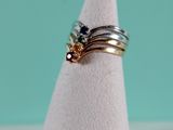 a stack of three rings sitting on top of a white cone