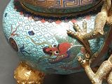 a blue vase with a gold dragon on top of it