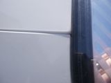 a reflection of a person in the side mirror of a car