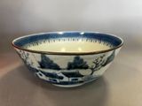 a blue and white bowl sitting on a table