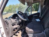 a white van with a steering wheel and a black seat