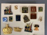 many different types of pins and badges on a piece of paper