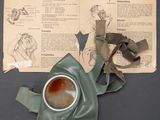 a gas mask on the table next to a book