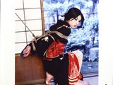 a picture of a woman in a kimono sitting on the floor