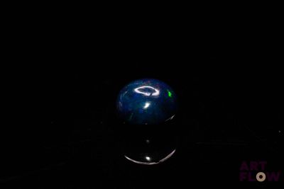 an image of a blue marble ball in the dark