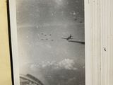 a black and white photo of a plane flying in the sky