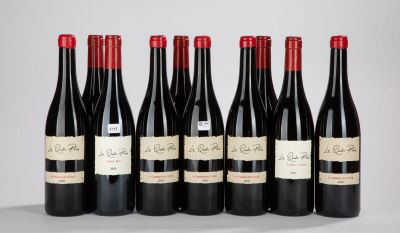 six bottles of red wine lined up in a row on a table