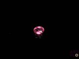a pink diamond on a black background