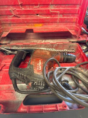 a red tool box with a hammer and a cord