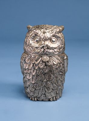 a silver owl figurine sitting on top of a blue surface