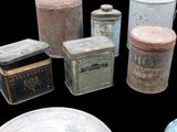 many different types of tins and containers on the table