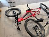 a bicycle that is laying on the floor next to a teddy bear
