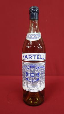 an empty bottle of martelli on a red background