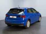 the rear end of a blue car in a showroom