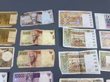 several different bills of different colors and shapes are laid out on a table
