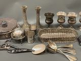 a lot of silverware on a table with spoons and spoons