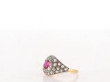 a close up of a pink stone ring on a white surface