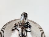 a silver box with a flower on top of it