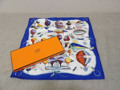 an orange box is sitting on a blue and white scarf