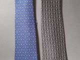 two ties that are sitting next to each other on a table