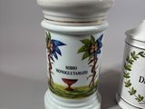 two salt and pepper shakers sitting next to each other